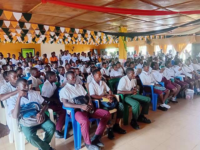 Students in school uniforms at a decorated hall event