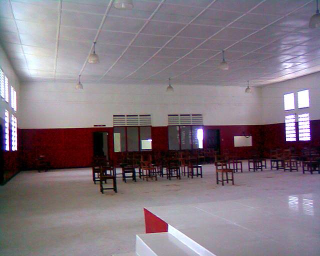 Renovated community hall with tiled floor and red-and-white walls